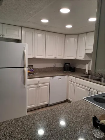 a kitchen with a sink stainless steel appliances and cabinets