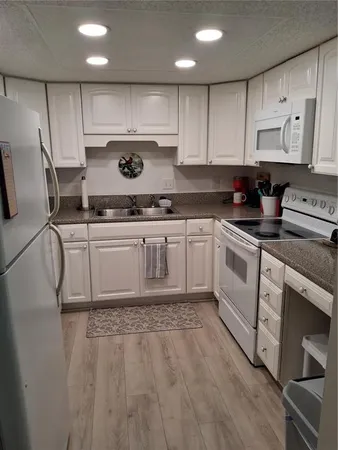a kitchen with stainless steel appliances granite countertop a sink and cabinets