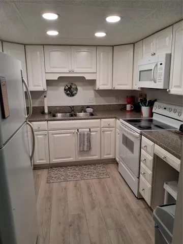 a kitchen with stainless steel appliances granite countertop a sink and cabinets
