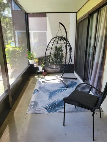 a living room with a rug and a window