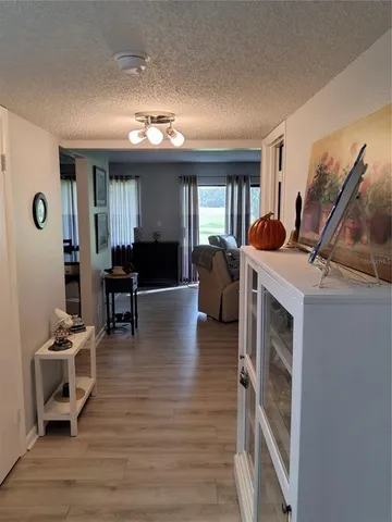 a view of a livingroom with furniture hardwood floor and workspace