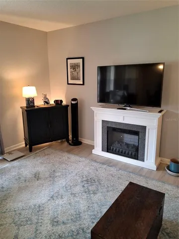 a living room with a fireplace and a flat screen tv