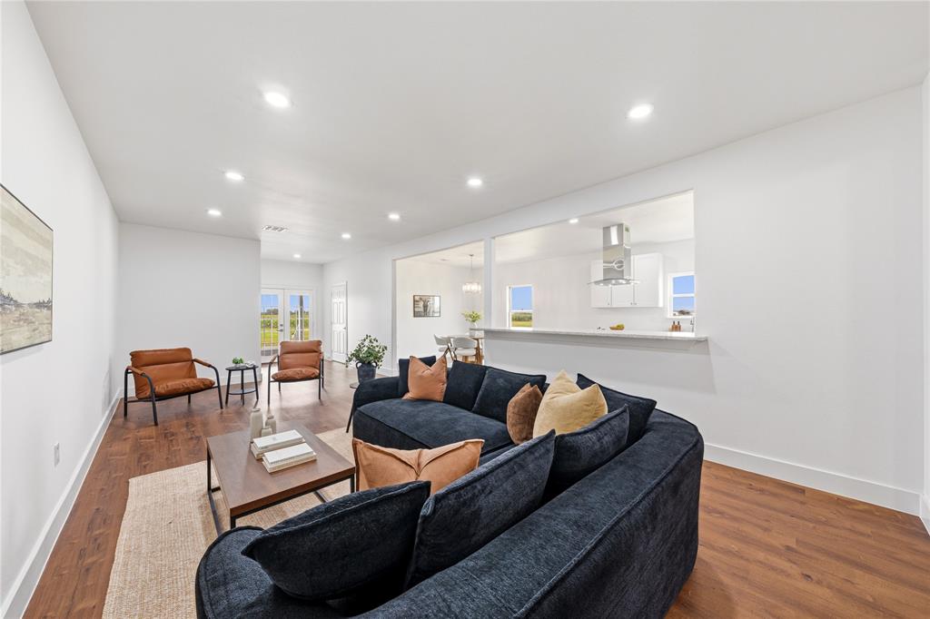 1128 Newton Road Ferris, TX 75125 - Photo 6 of 28 Open-concept living space featuring wood-finish flooring, recessed lighting, and white walls