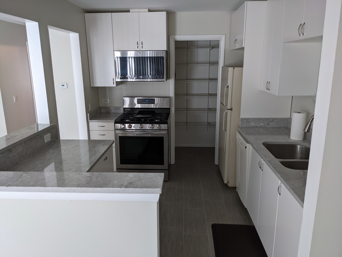 70 Margate Court, Unit C2 Schaumburg, IL 60193 - Photo 16 of 35 a kitchen with stainless steel appliances a stove and a refrigerator