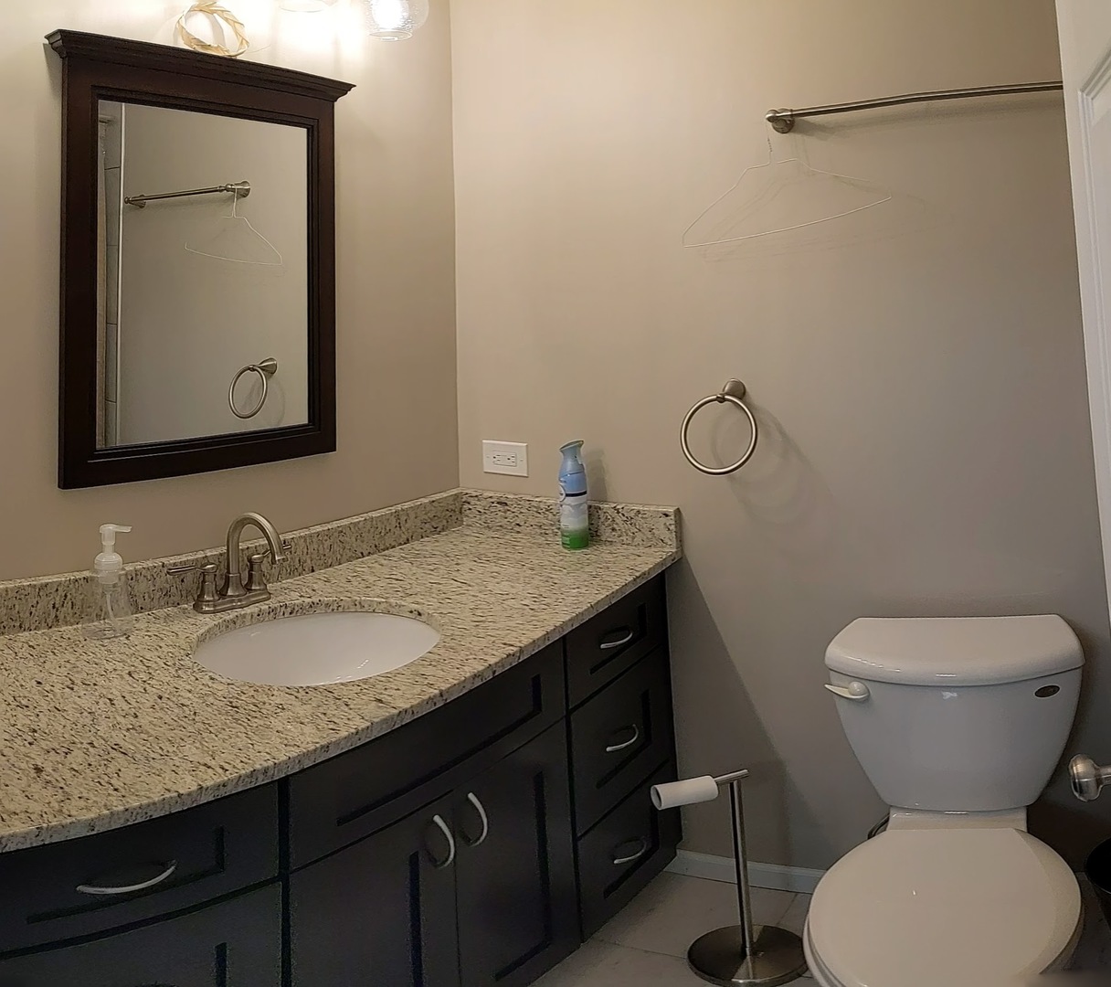 70 Margate Court, Unit C2 Schaumburg, IL 60193 - Photo 32 of 35 a bathroom with a granite countertop toilet sink and mirror