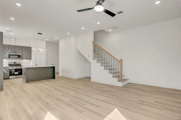 a view of kitchen with wooden floor and electronic appliances