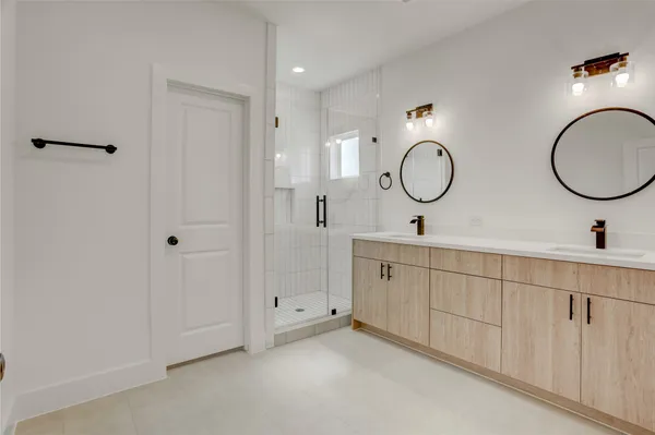 a bathroom with 2 sink and a mirror