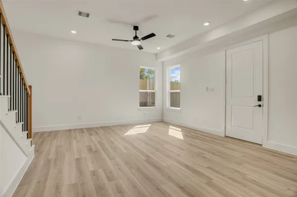 wooden floor in an empty room with a window