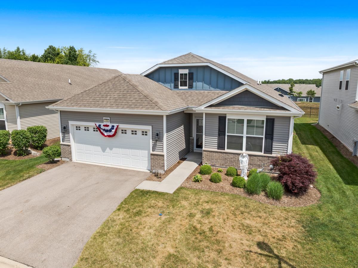 1150 Americana Avenue Pingree Grove, IL 60140 - Photo 1 of 30 a front view of a house with a yard and garage