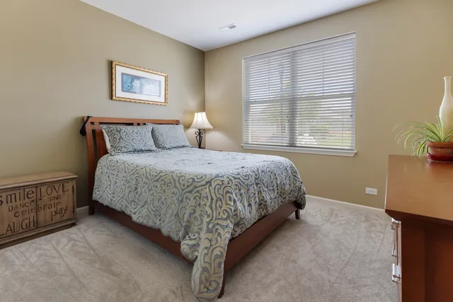 a bedroom with a bed and a night stand