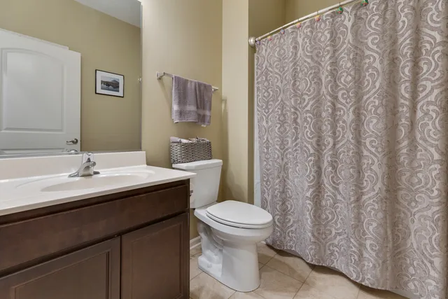 a bathroom with a granite countertop sink toilet and a mirror