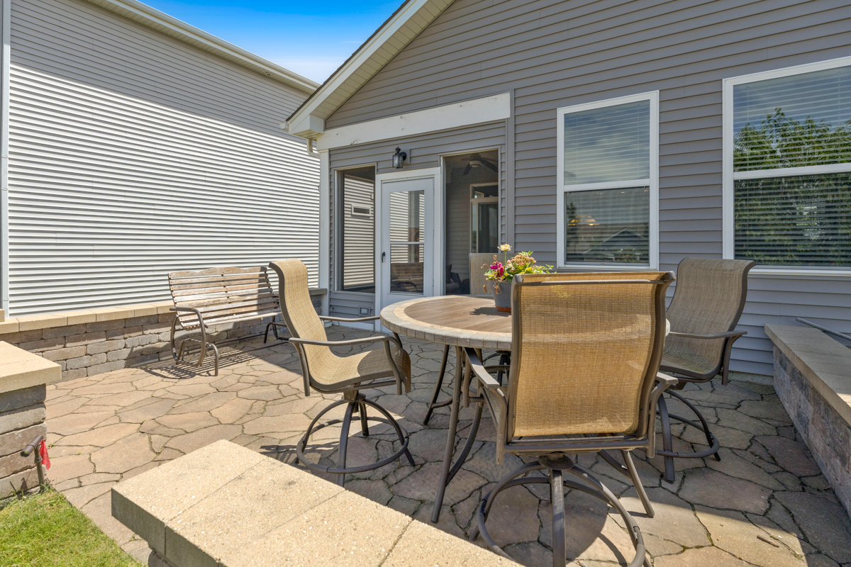 1150 Americana Avenue Pingree Grove, IL 60140 - Photo 20 of 30 a patio with table and chairs and potted plants