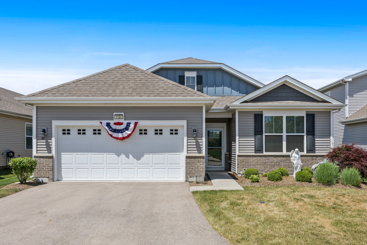 1150 Americana Avenue Pingree Grove, IL 60140 - Photo 2 of 30 a front view of a house with a garage