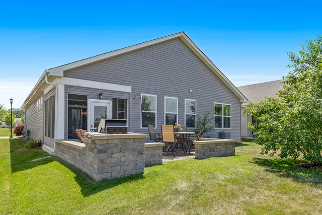 a front view of house with deck and yard