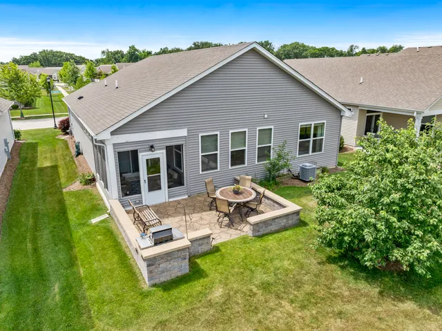 a view of a house with backyard sitting area and garden