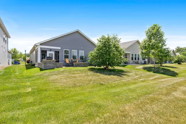 a view of a house with a big yard and palm trees