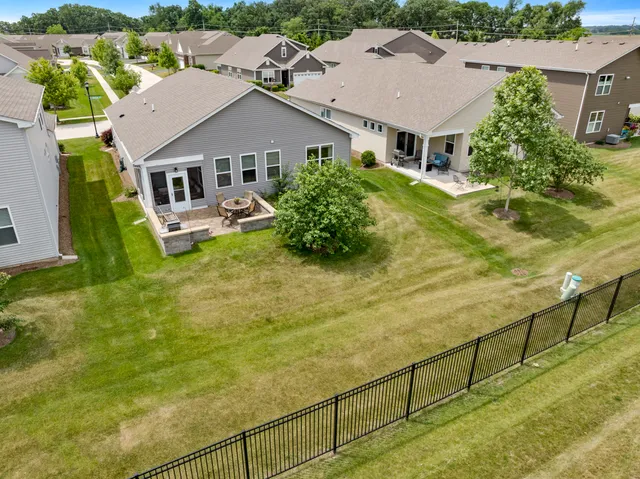 an aerial view of residential houses with yard