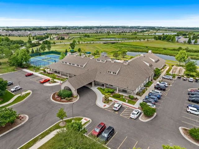 an aerial view of a house with garden space and ocean view