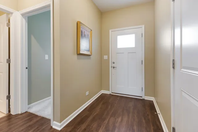 a view of a hallway with wooden floor