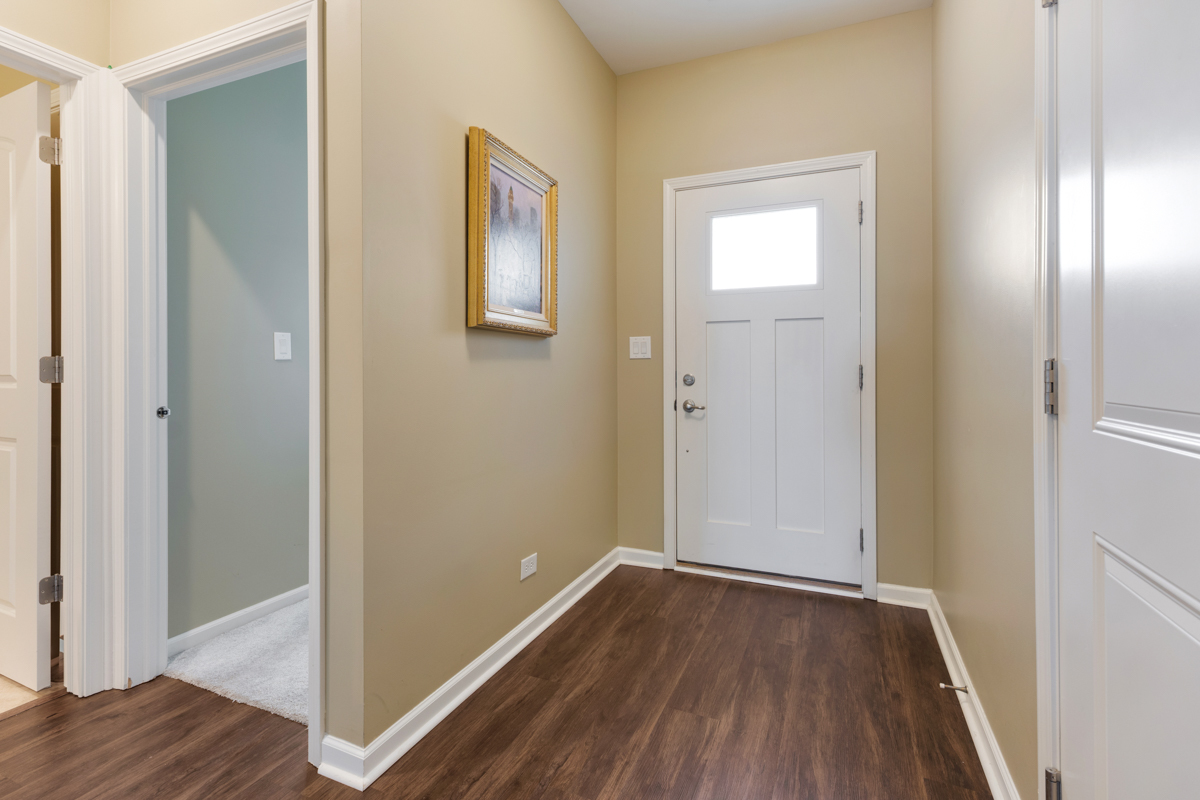1150 Americana Avenue Pingree Grove, IL 60140 - Photo 3 of 30 a view of a hallway with wooden floor