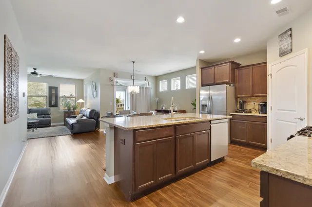 a large kitchen with a large counter top appliances and cabinets
