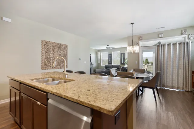 a kitchen with a table chairs and wooden floor
