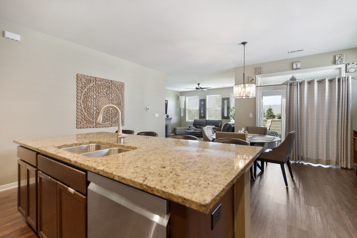 1150 Americana Avenue Pingree Grove, IL 60140 - Photo 8 of 30 a kitchen with a table chairs and wooden floor
