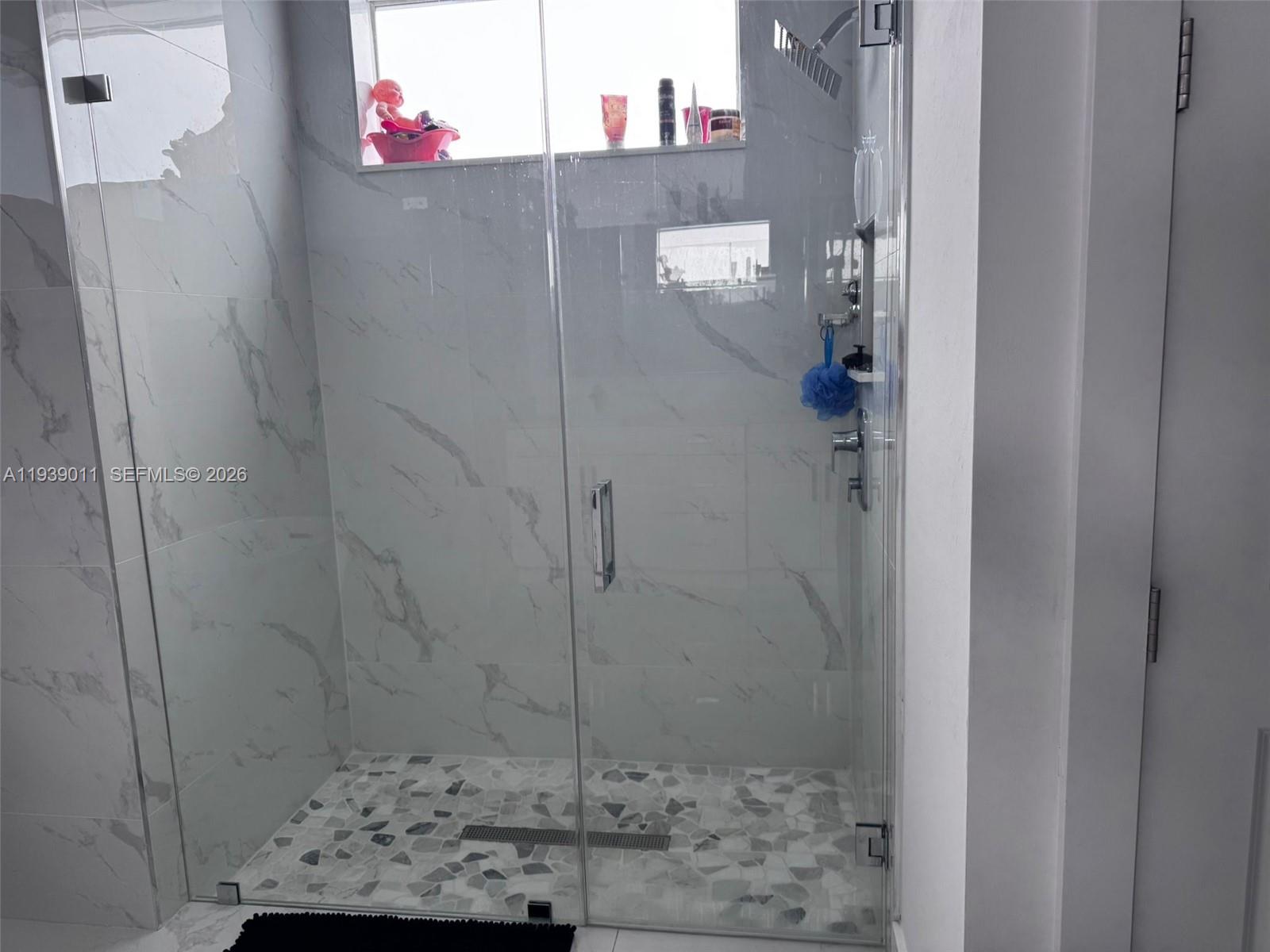 11 Connecticut Road Lehigh Acres, FL 33936 - Photo 8 of 11 a bathroom with a shower