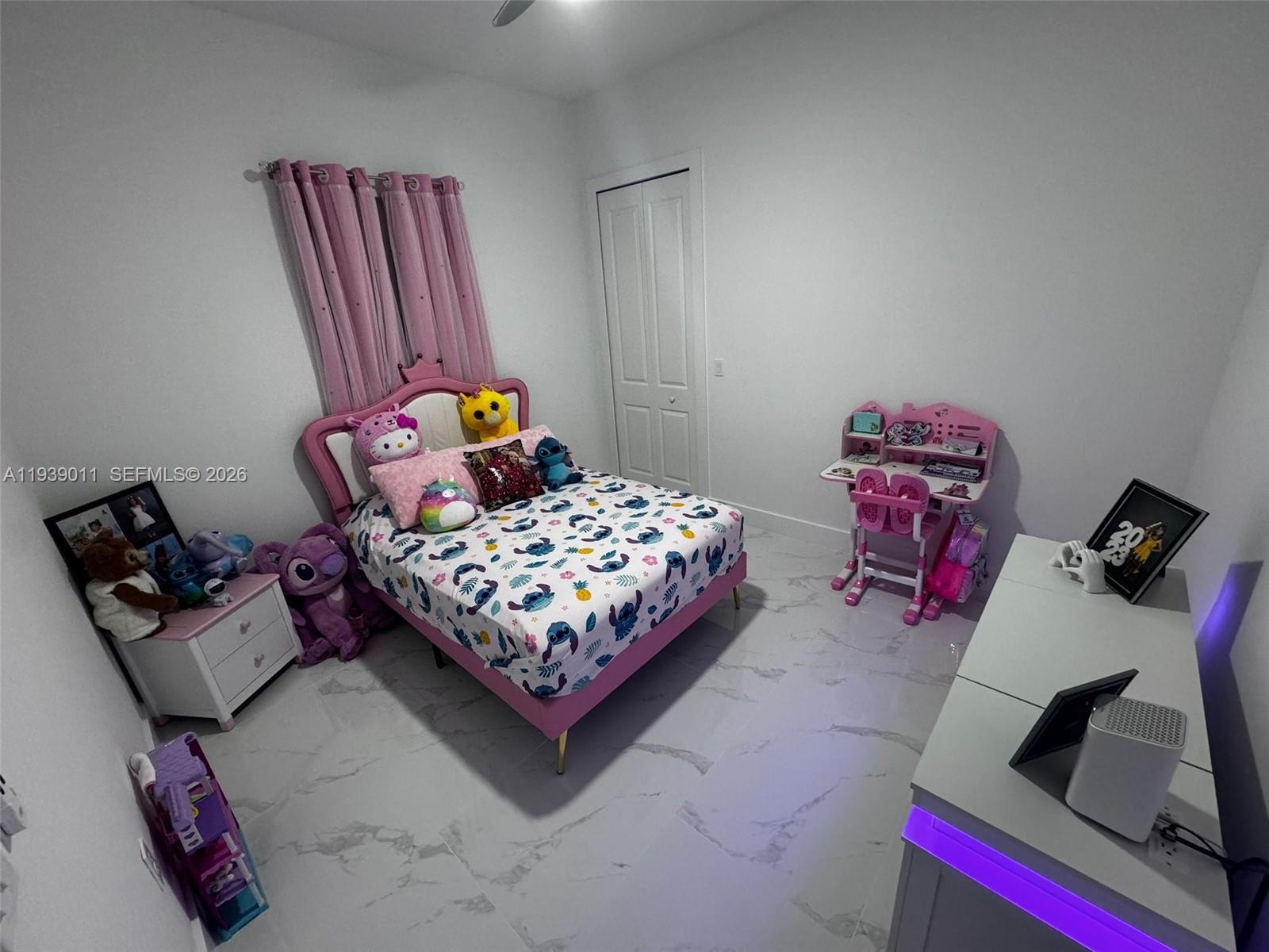 11 Connecticut Road Lehigh Acres, FL 33936 - Photo 9 of 11 a bedroom with bed and a couch