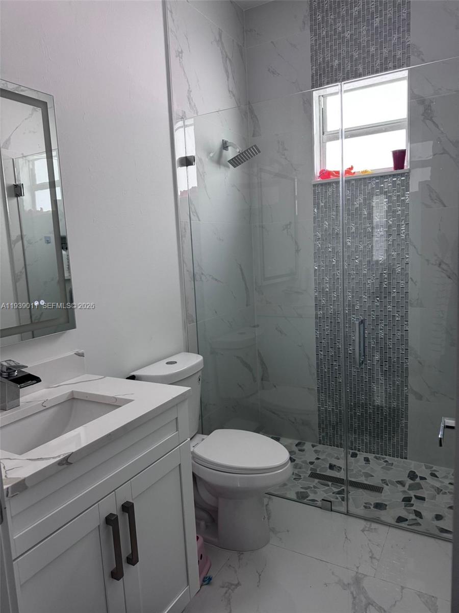 11 Connecticut Road Lehigh Acres, FL 33936 - Photo 10 of 11 a bathroom with a sink a toilet and shower