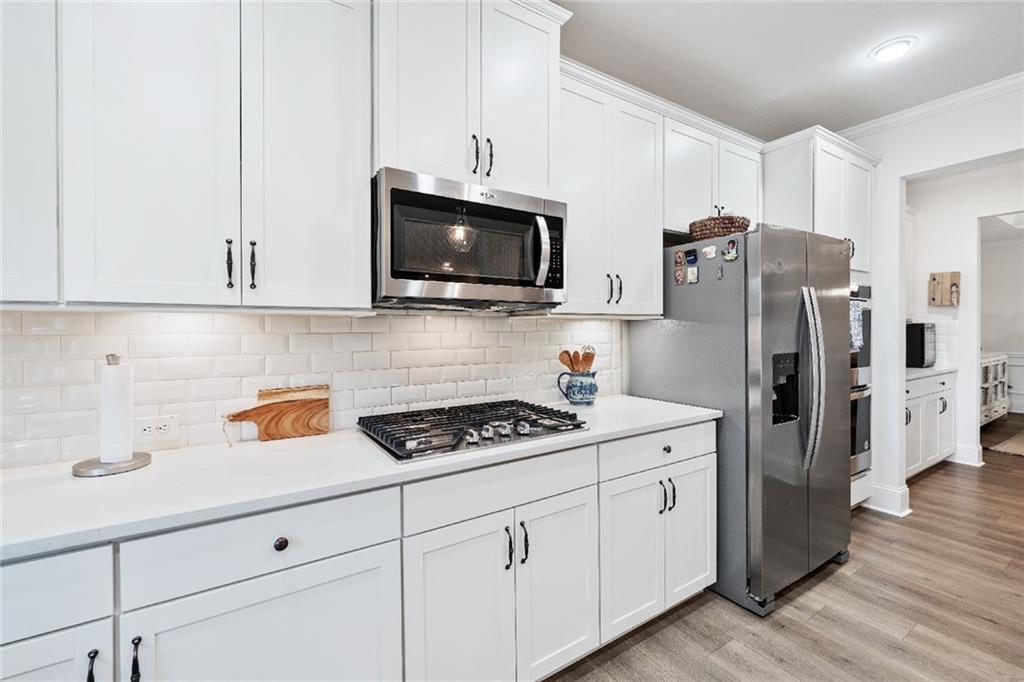 7545 Rambling Vale Dawsonville, GA 30534 - Photo 11 of 46 a kitchen with stainless steel appliances granite countertop a refrigerator sink and microwave