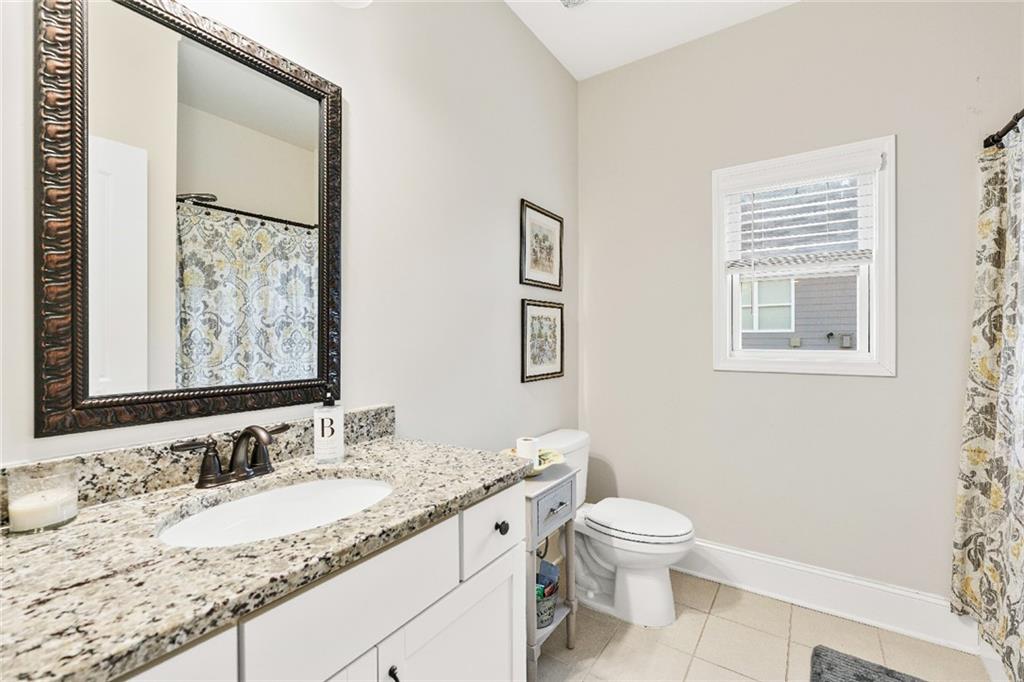 7545 Rambling Vale Dawsonville, GA 30534 - Photo 14 of 46 a bathroom with a granite countertop sink a toilet and a mirror