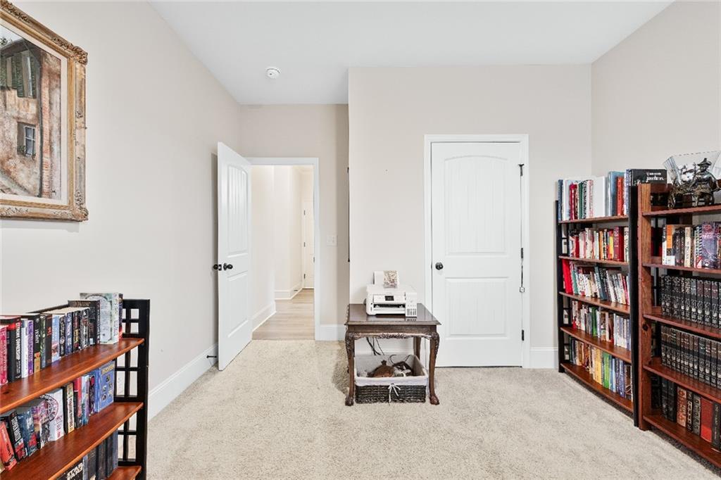 7545 Rambling Vale Dawsonville, GA 30534 - Photo 16 of 46 a view of a workspace with furniture and book shelf