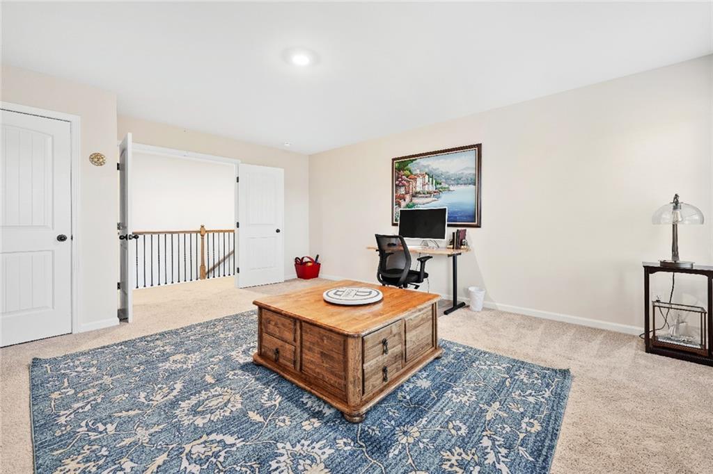 7545 Rambling Vale Dawsonville, GA 30534 - Photo 27 of 46 a living room with hard wood walls and a table