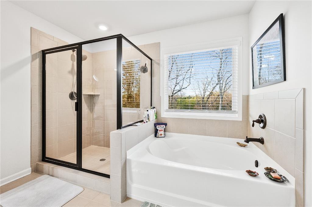 7545 Rambling Vale Dawsonville, GA 30534 - Photo 31 of 46 a bathroom with a bathtub and a shower