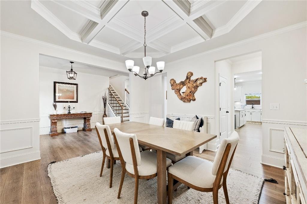 7545 Rambling Vale Dawsonville, GA 30534 - Photo 6 of 46 a dining room with furniture a chandelier and wooden floor
