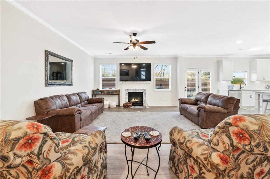 7545 Rambling Vale Dawsonville, GA 30534 - Photo 7 of 46 a living room with furniture a flat screen tv and a fireplace