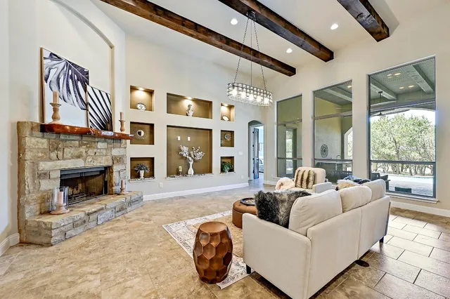 a living room with furniture large window and a fireplace