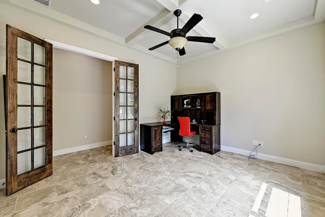 a view of a livingroom with a ceiling fan and window