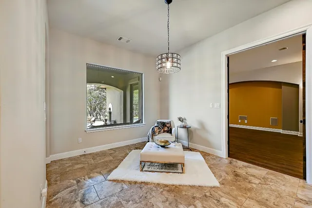 a living room with a bath tub and a chandelier