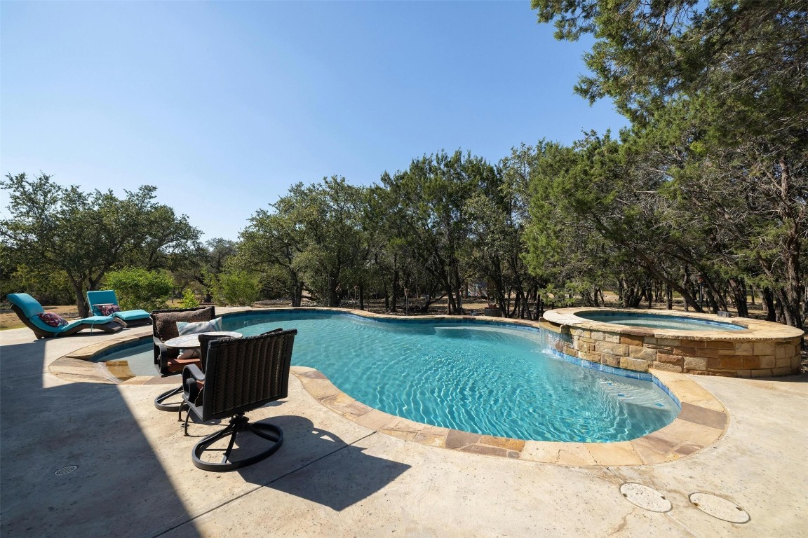 221 Tower Road Georgetown, TX 78628 - Photo 2 of 40 a view of a swimming pool and lounge chair