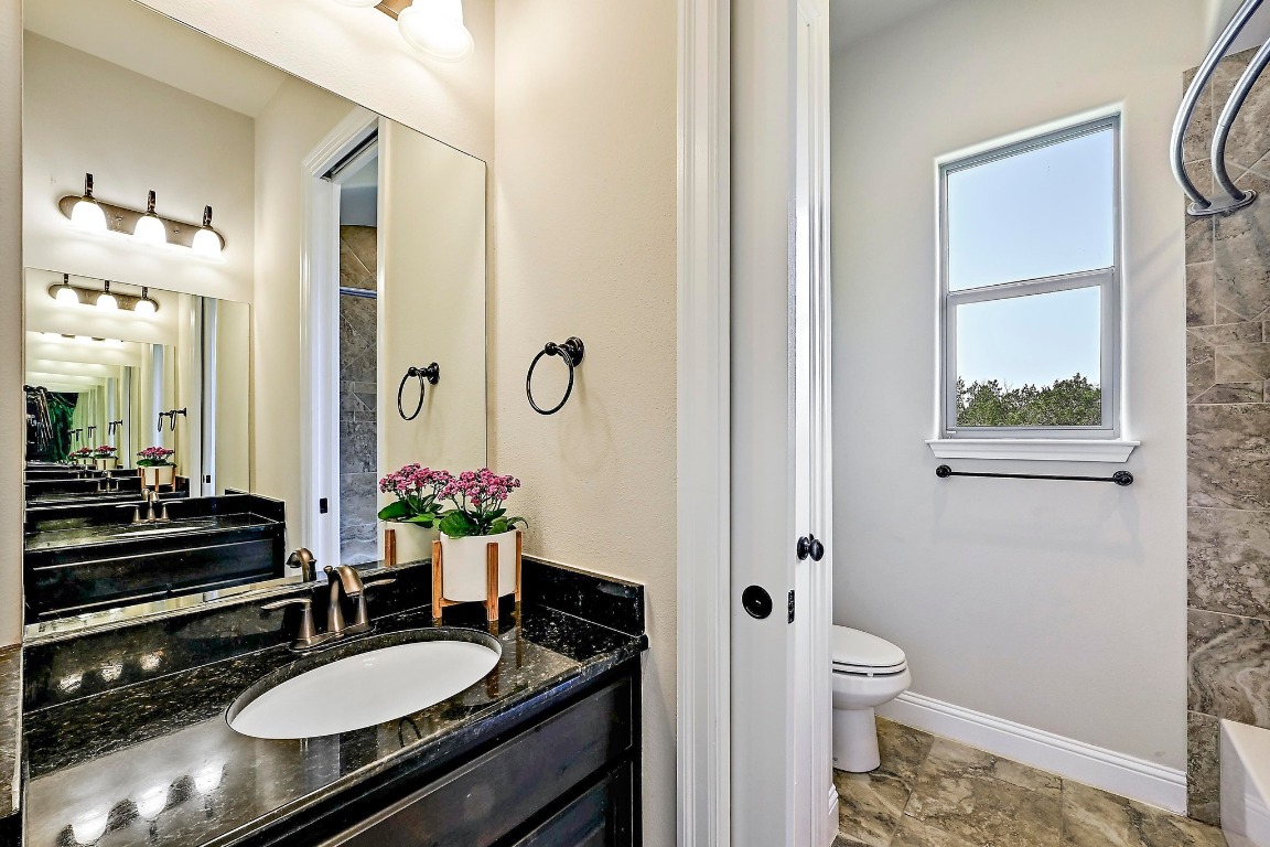 221 Tower Road Georgetown, TX 78628 - Photo 23 of 40 a bathroom with a sink a toilet and a mirror