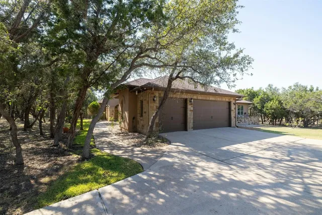 a view of a house with yard and tree s