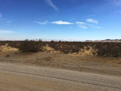 a view of an ocean beach and mountain
