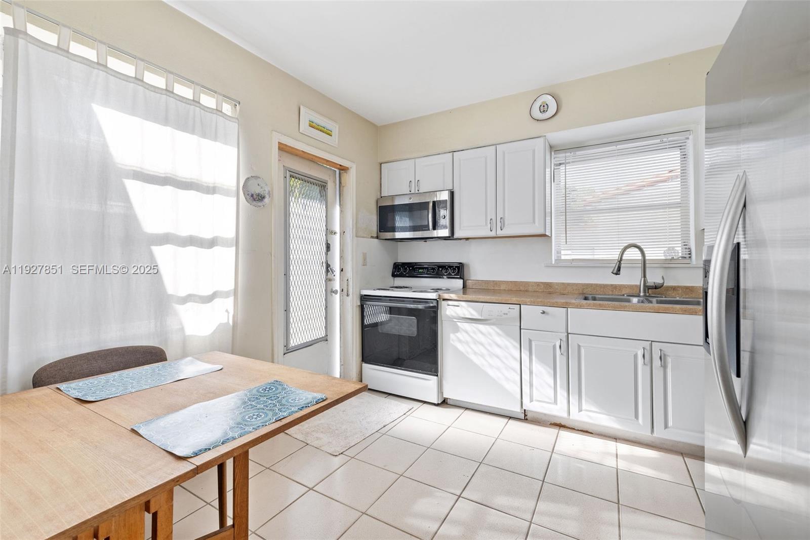 3310 Southwest 21st Street Miami, FL 33145 - Photo 16 of 20 a kitchen with a stove a sink and a refrigerator