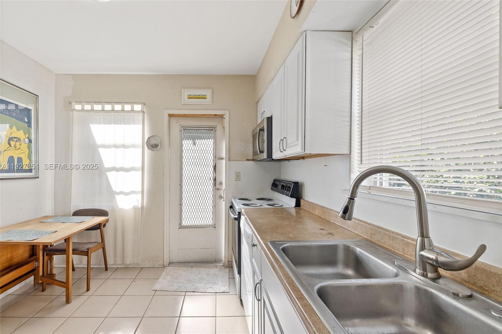3310 Southwest 21st Street Miami, FL 33145 - Photo 17 of 20 a kitchen with a sink cabinets a stove and a window