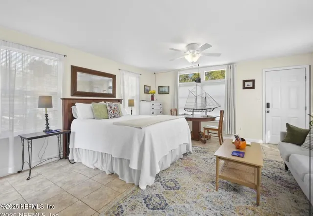 a bedroom with furniture and a chandelier