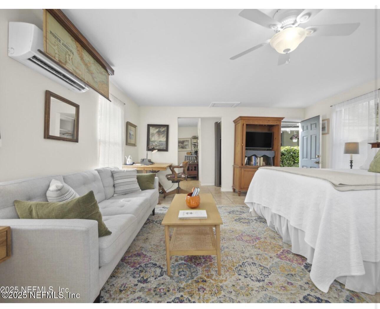 509 Live Oak Street, Unit 1 St. Augustine, FL 32084 - Photo 4 of 9 a living room with furniture fireplace and a chandelier