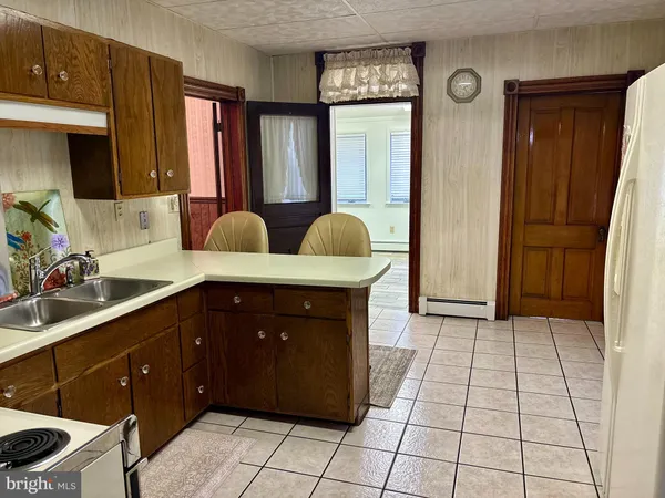 a kitchen with a sink a stove and a refrigerator