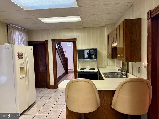 a kitchen with stainless steel appliances a refrigerator and a stove